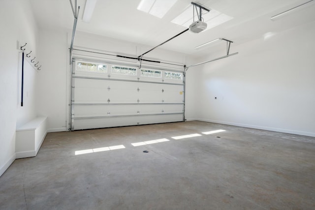 garage featuring a garage door opener and baseboards