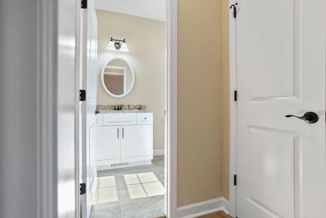 bathroom with baseboards and vanity