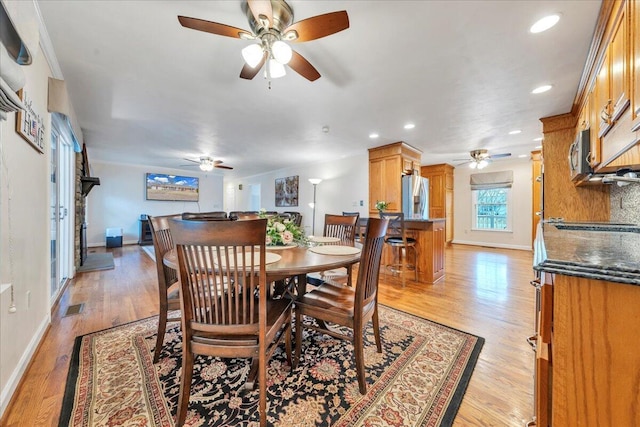 dining room featuring light wood-type flooring, baseboards, and visible vents