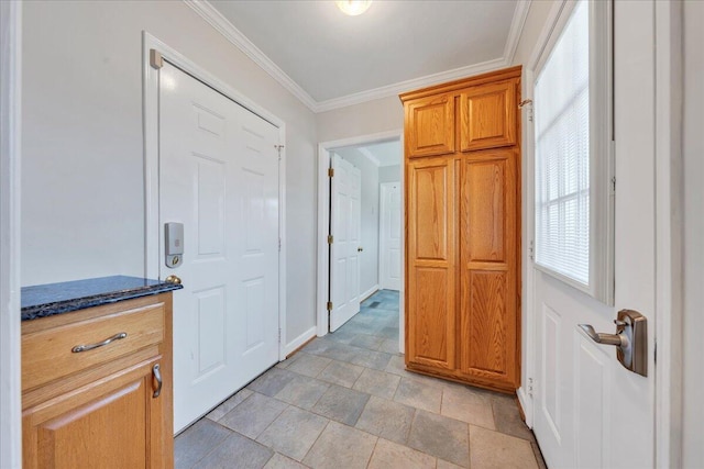 interior space featuring baseboards and ornamental molding