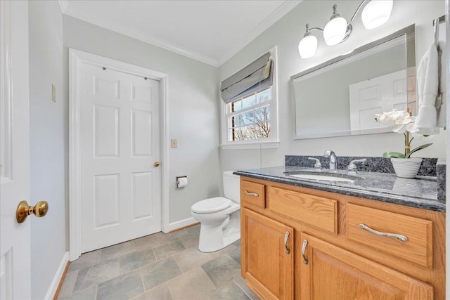 bathroom featuring toilet, baseboards, crown molding, and vanity