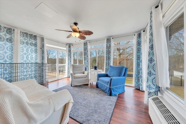 sunroom / solarium with a wall mounted AC and a ceiling fan