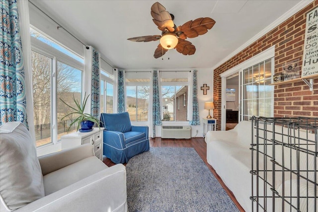 sunroom with a ceiling fan and a wall unit AC