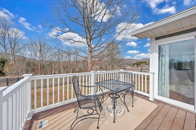 wooden terrace with outdoor dining space