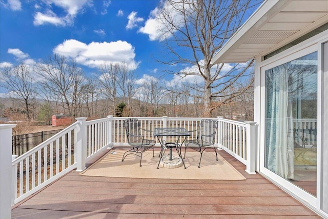 wooden terrace with outdoor dining area