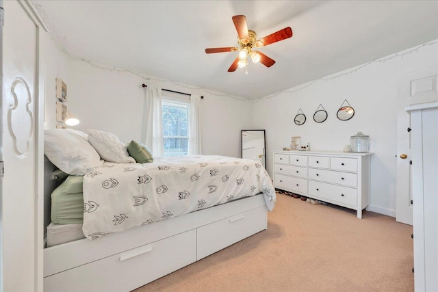 bedroom featuring light carpet and a ceiling fan