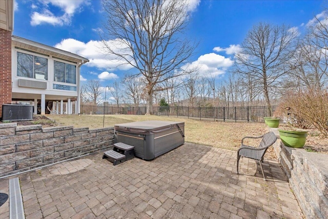 view of patio / terrace with central AC, a hot tub, and a fenced backyard