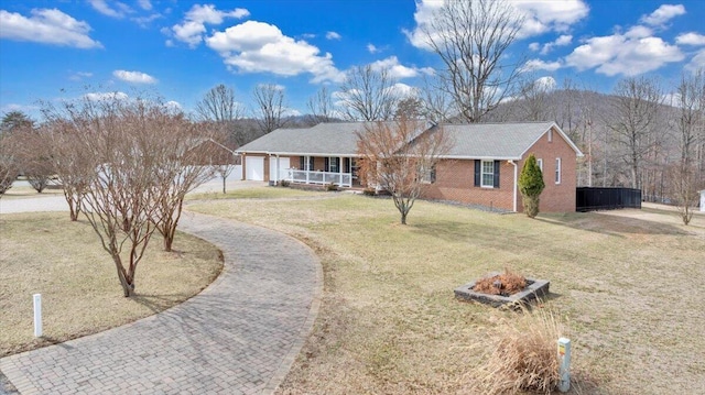 ranch-style house with brick siding, an attached garage, covered porch, decorative driveway, and a front yard