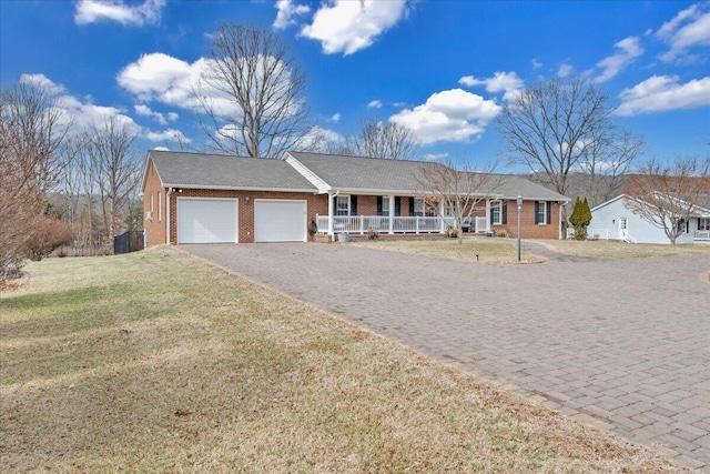 ranch-style home with driveway, a garage, a porch, a front lawn, and brick siding