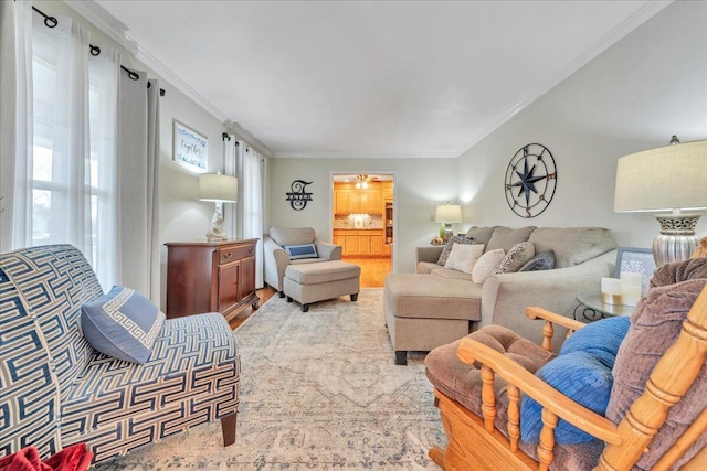 living room with crown molding and wood finished floors