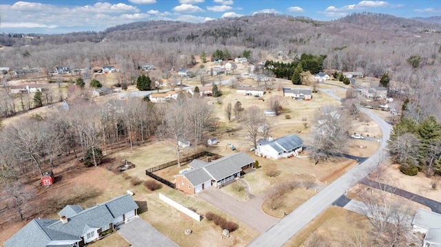 birds eye view of property with a view of trees