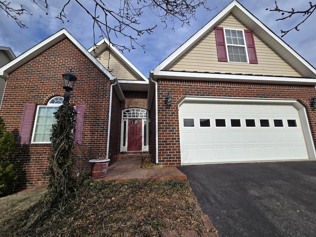 view of front of property featuring driveway, brick siding, and an attached garage