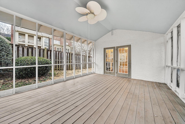 unfurnished sunroom with lofted ceiling and a ceiling fan