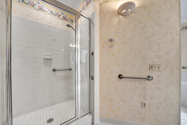 full bath with tile patterned floors, a shower stall, and wallpapered walls