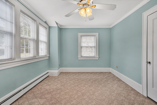 carpeted spare room featuring baseboards, plenty of natural light, a baseboard heating unit, and crown molding