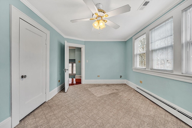 unfurnished bedroom with carpet floors, visible vents, a baseboard heating unit, and ornamental molding