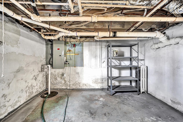 unfinished basement with radiator heating unit and electric panel