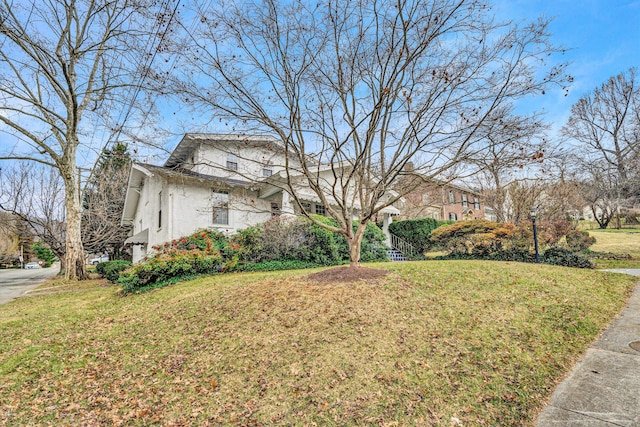 view of front of home with a front lawn and stucco siding