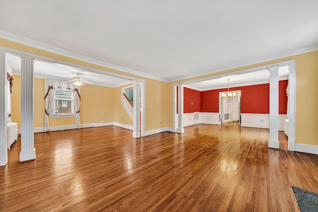 unfurnished living room featuring wood-type flooring, ornate columns, and ceiling fan with notable chandelier