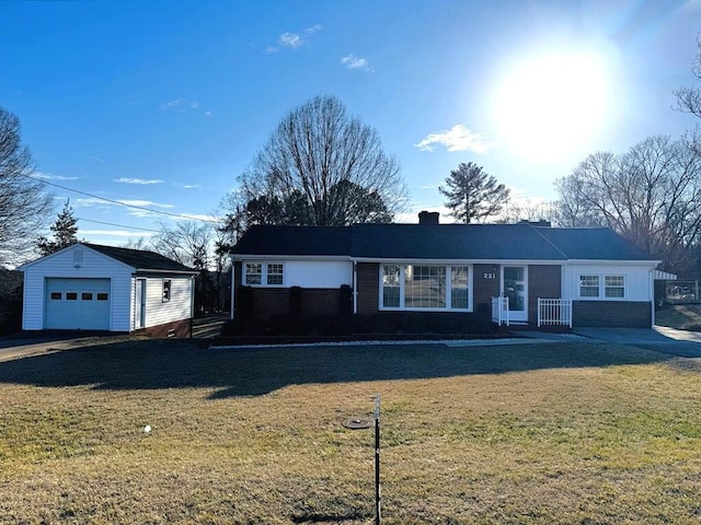 single story home with a chimney, a detached garage, an outbuilding, a front lawn, and brick siding