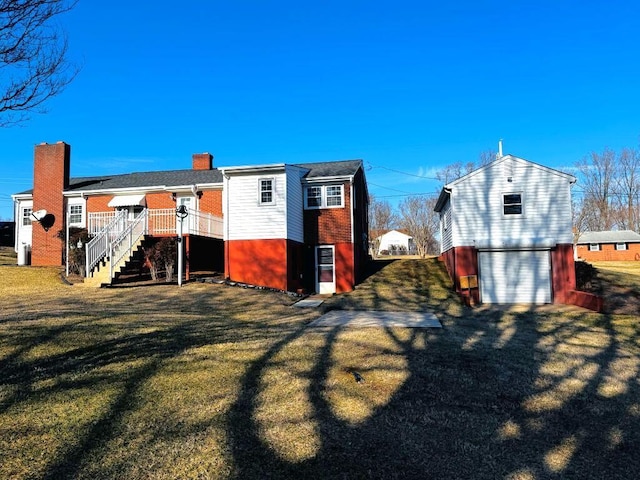 exterior space with brick siding, stairs, a yard, driveway, and a chimney