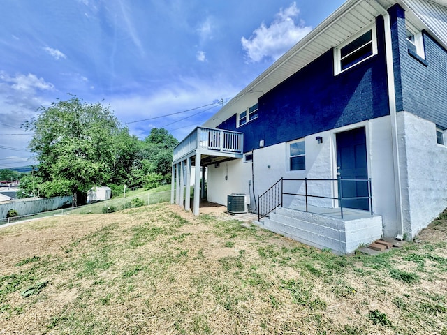 418 Victor Ave NE, Roanoke, VA 24012 - rear view of property featuring stucco siding, a lawn, fence, and central air condition unit