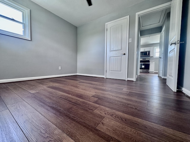 418 Victor Ave NE, Roanoke, VA 24012 - empty room with dark wood-type flooring, attic access, and baseboards
