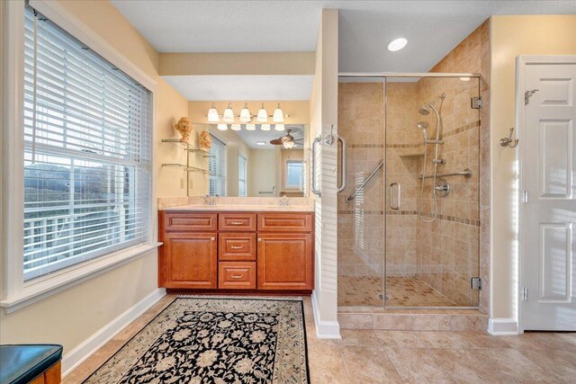 bedroom featuring baseboards, light wood finished floors, ceiling fan, a textured ceiling, and access to outside