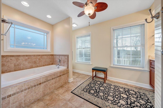 bathroom featuring baseboards, recessed lighting, ceiling fan, tile patterned flooring, and a bath