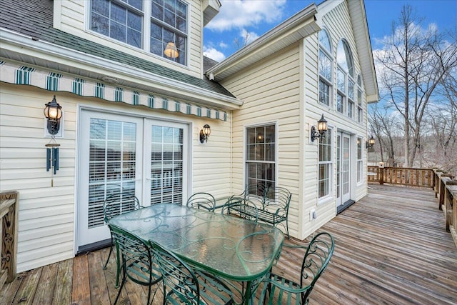 wooden terrace featuring outdoor dining area and french doors