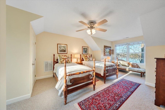 carpeted bedroom with visible vents, ceiling fan, baseboards, lofted ceiling, and a textured ceiling