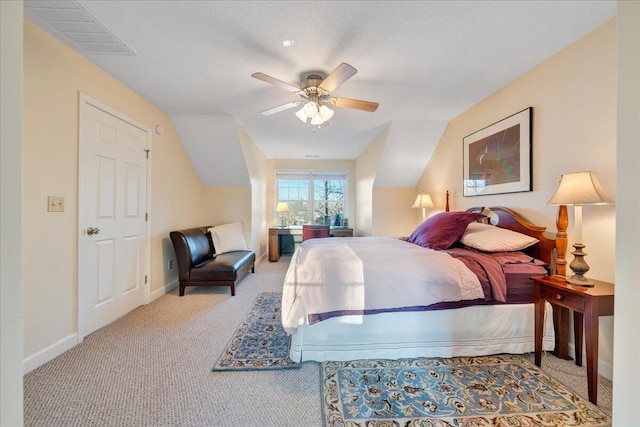 bedroom featuring baseboards, visible vents, carpet floors, ceiling fan, and vaulted ceiling