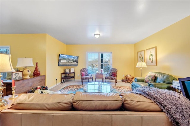 living room featuring carpet and baseboards