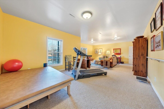 workout area featuring visible vents, carpet flooring, and baseboards