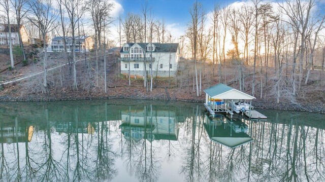 dock area with a water view and boat lift