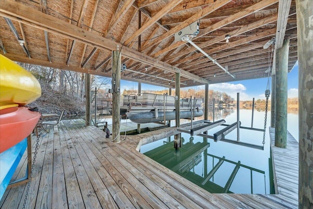 dock area with boat lift and a water view