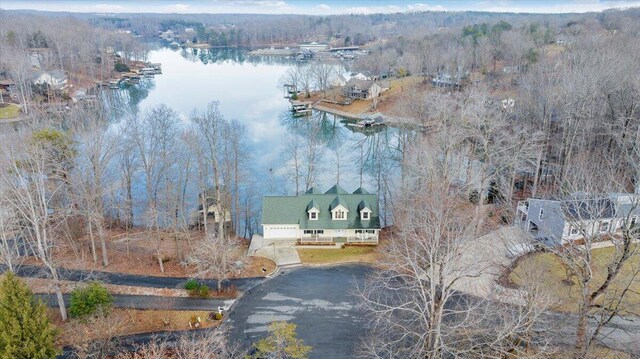 birds eye view of property with a water view and a view of trees