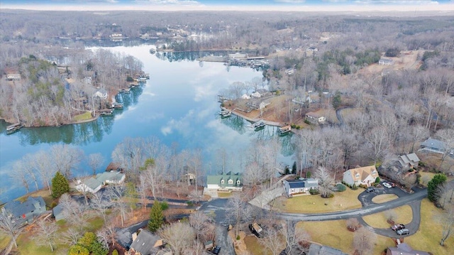 drone / aerial view featuring a view of trees and a water view