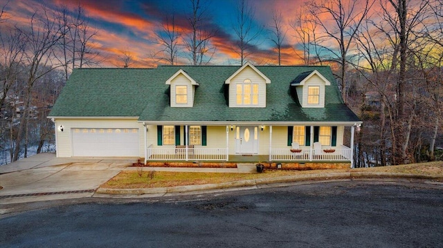 cape cod house featuring a garage, a porch, concrete driveway, and a shingled roof