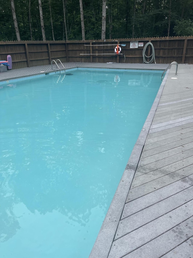 view of swimming pool with a fenced in pool and fence