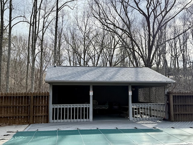 view of swimming pool featuring fence