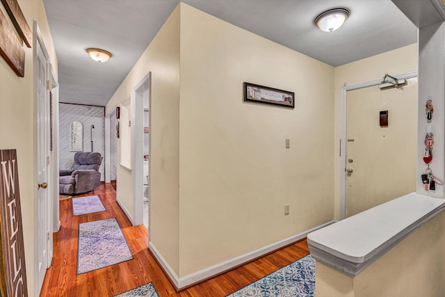 interior space featuring baseboards and wood finished floors