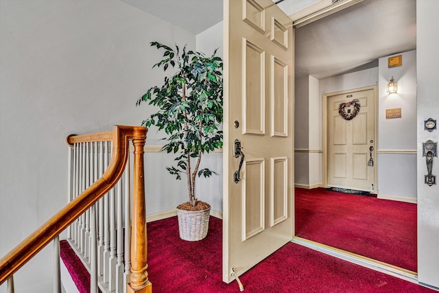 hall with baseboards and carpet flooring