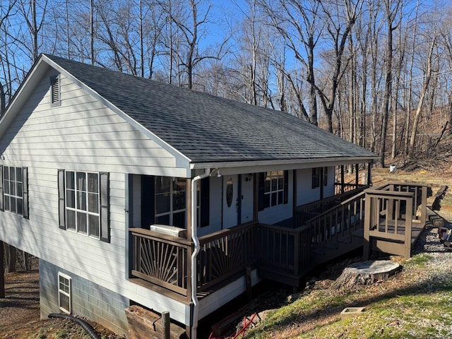 view of front of house featuring a shingled roof and a porch