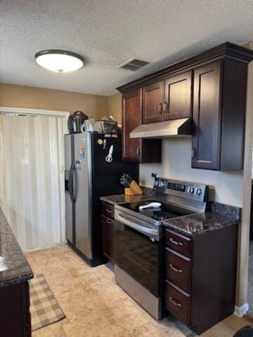 kitchen featuring dark brown cabinetry, under cabinet range hood, visible vents, appliances with stainless steel finishes, and dark stone counters