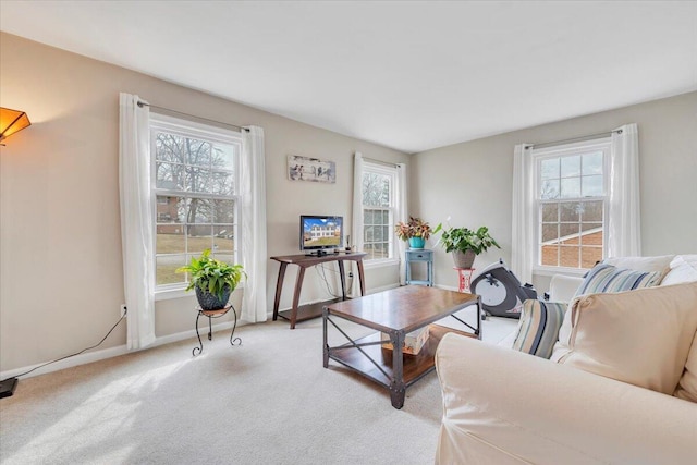 living room featuring light carpet and baseboards