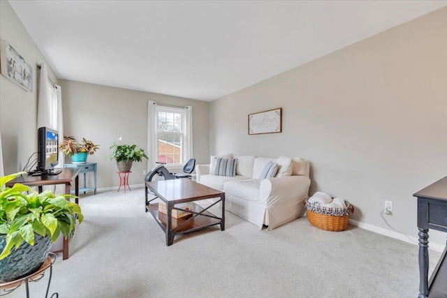 carpeted living area with baseboards