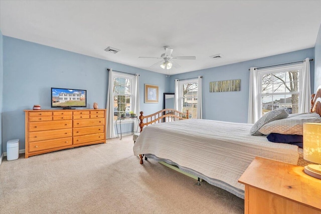 carpeted bedroom with ceiling fan and visible vents