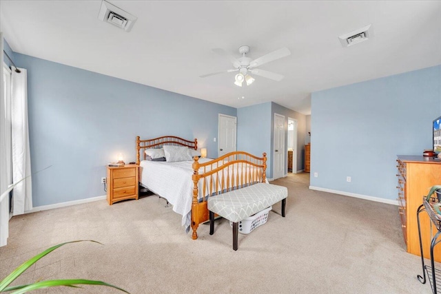 carpeted bedroom featuring a ceiling fan, visible vents, and baseboards