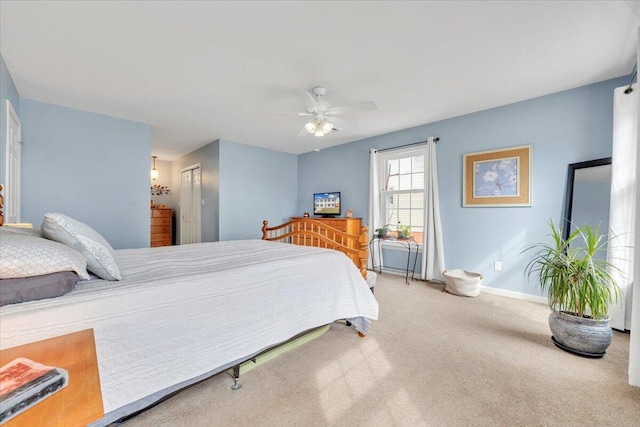 bedroom with baseboards, a closet, a ceiling fan, and carpet flooring